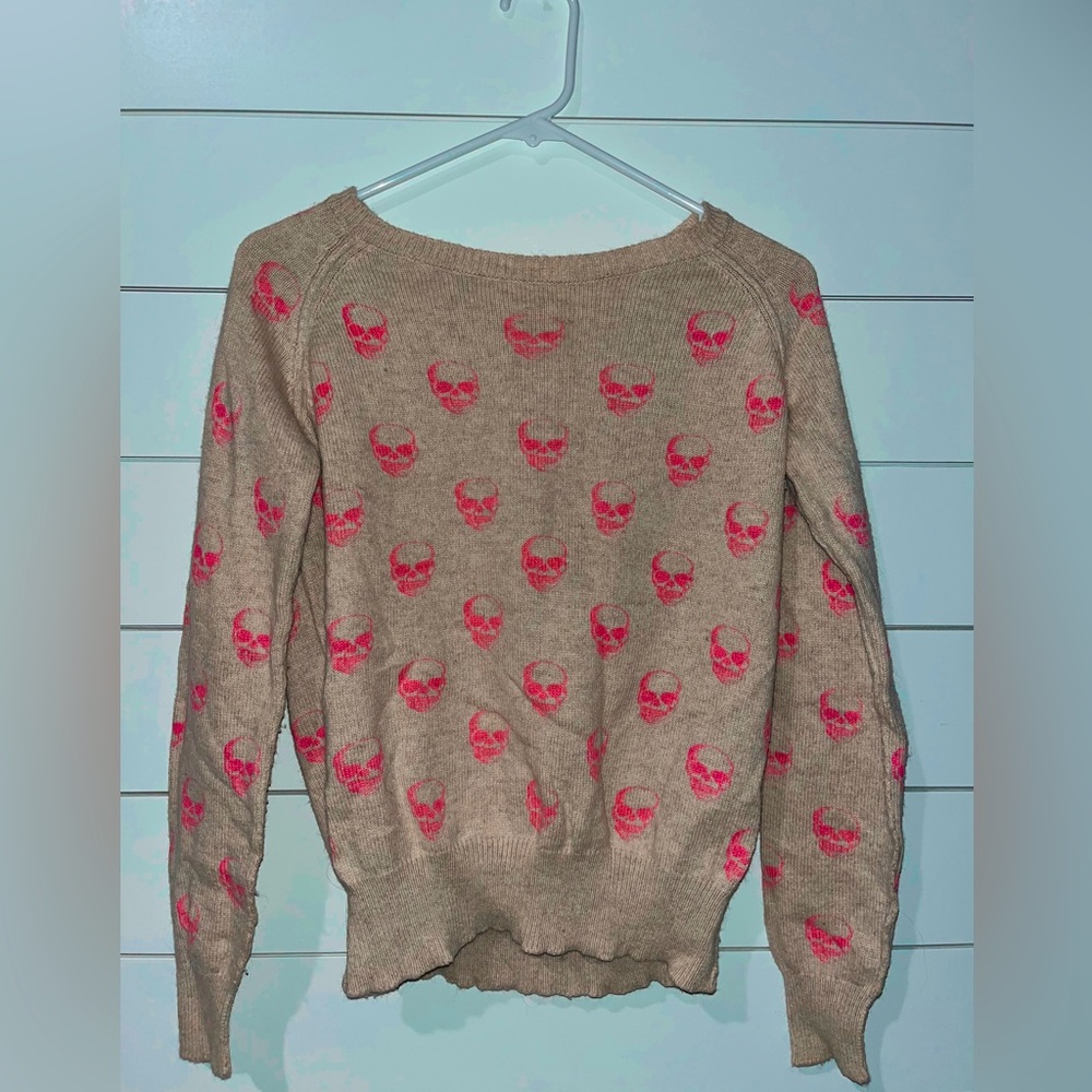 light brown sweater with hot pink skeletons